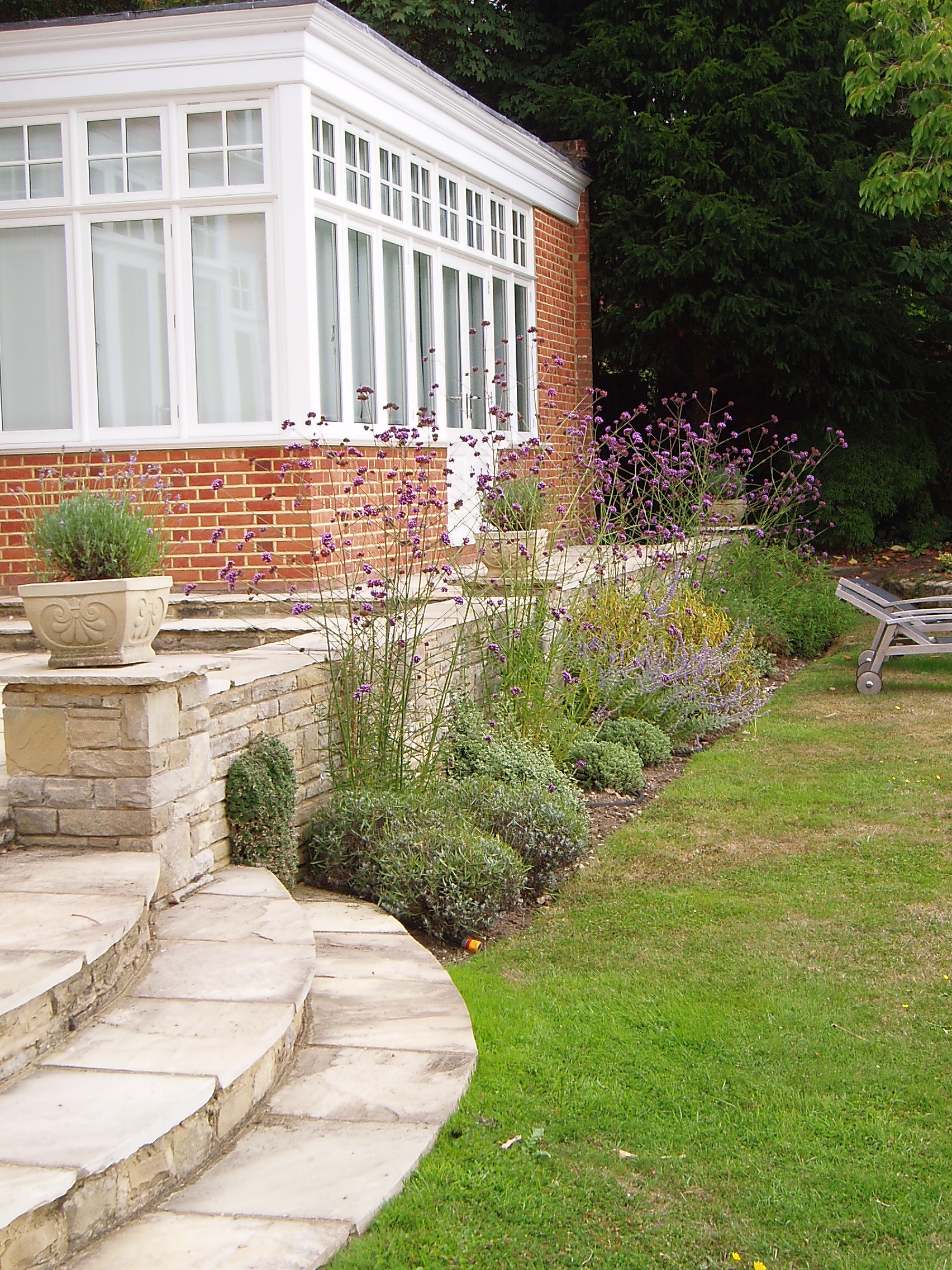 New beds featuring a mix of evergreen and flowering shrubs